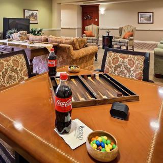A cozy living room with a table set for backgammon and refreshments.
