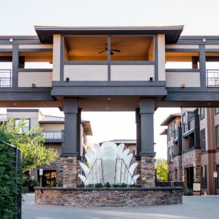 Modern commercial building with a central fountain.