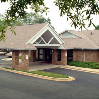 A well-designed building with a welcoming entrance and landscaped surroundings.