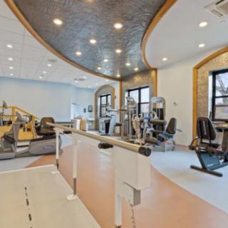 A modern gym interior equipped with various exercise machines.