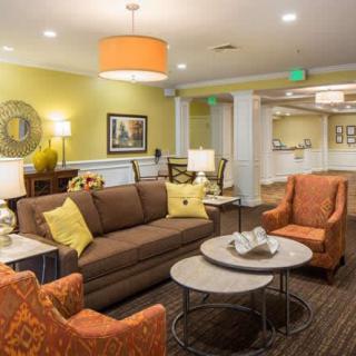 A cozy living room featuring a sofa, armchairs, and stylish decor.