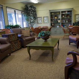 A cozy living room with comfortable seating and decorative elements.