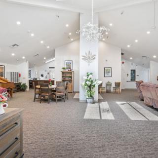 Spacious living area with dining setup and elegant decor.
