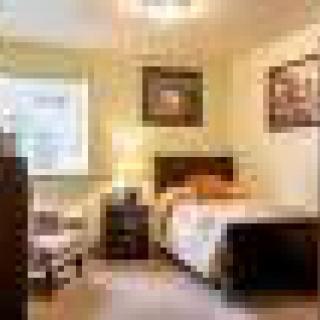 A cozy bedroom with stylish decor and ample natural light.