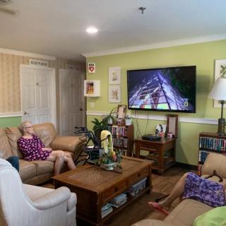 Two people relaxing in a cozy living room while watching television.