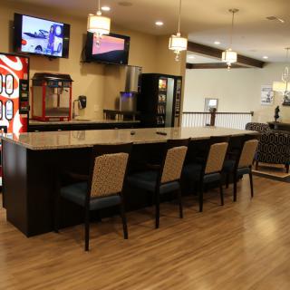 A modern bar interior with seating and a vending machine.