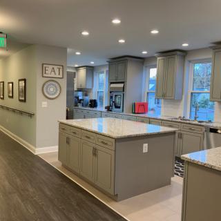 A spacious, modern kitchen with central islands and ample lighting.
