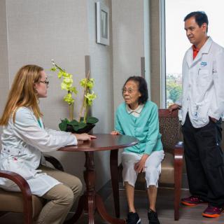 Doctors consulting with a patient in a medical office.