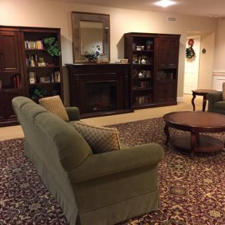 A cozy living room with a sofa, bookshelves, and a coffee table.