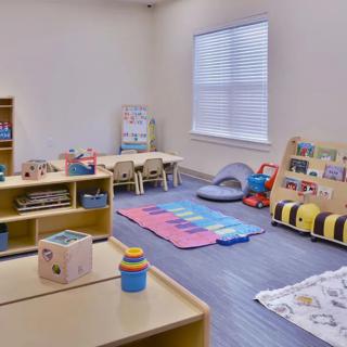 A well-organized preschool classroom with educational toys and a designated play area.