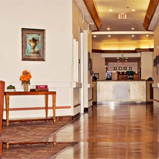 A hotel's welcoming lobby with a view of the reception desk and elegant decor.