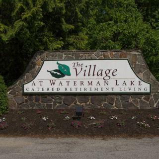 Entrance sign for The Village at Waterman Lake retirement community.