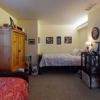 Cozy bedroom with a bed, wardrobe, and decorative elements.
