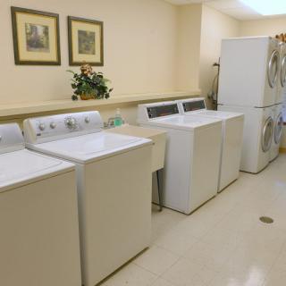 A well-organized laundry room with washing machines and dryers.