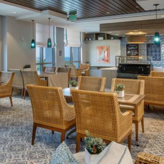 A modern cafe interior with wicker seating and stylish decorations.