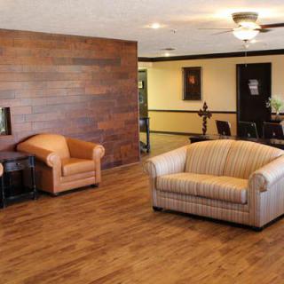A cozy living room with wooden flooring and comfortable furniture.