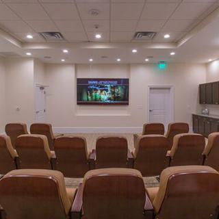 A cozy home theater setup with comfortable seating and a large screen.