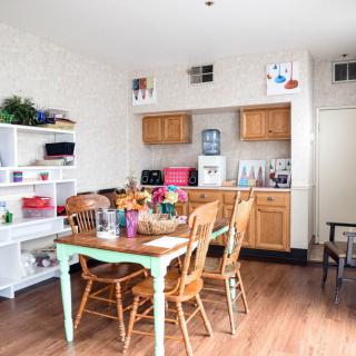 A cozy kitchen and dining area featuring wooden furniture and decorative elements.