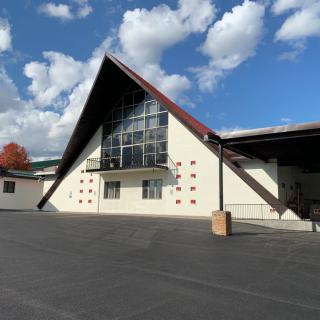 A modern building with unique angular architecture under a partly cloudy sky.
