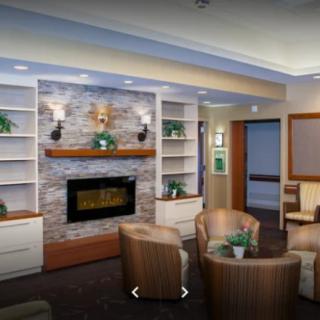 A modern living room with a fireplace and comfortable seating.