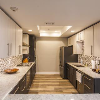 Modern kitchen with sleek design and ample lighting.