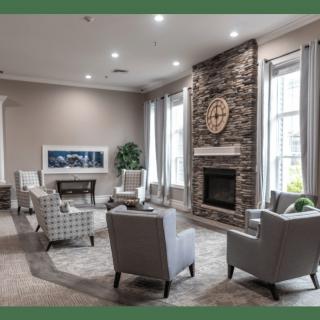 A modern living room with a stone fireplace and comfortable seating arrangement.