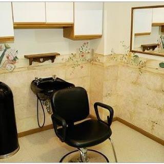 A cozy hair salon setup with a barber chair and washing station.