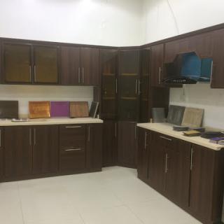 A modern kitchen showroom displaying various cabinetry and material samples.