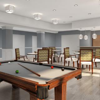 A modern game room featuring a pool table and seating area.