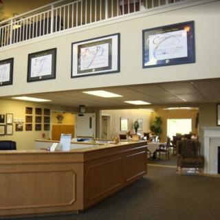 A spacious office lobby featuring a reception desk and comfortable waiting area.