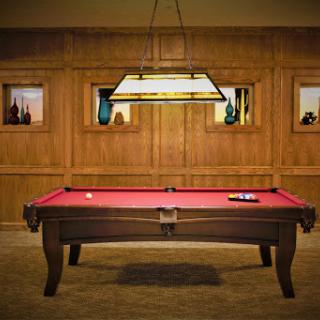 A stylish pool table set in an elegant game room, complete with warm wood paneling and ambient lighting.