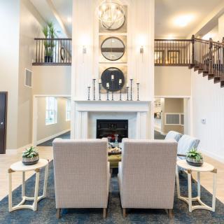 A modern living room with a fireplace and stylish decor.