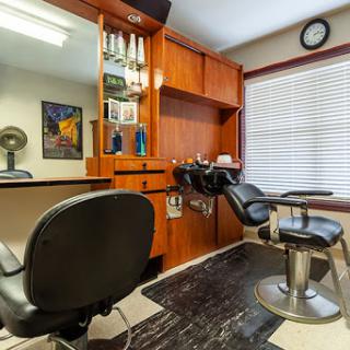 A stylish and well-organized barber shop interior featuring comfortable chairs and essential grooming tools.