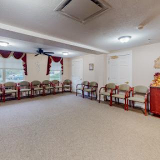 A spacious and inviting waiting area with rows of chairs, designed for comfort and relaxation.