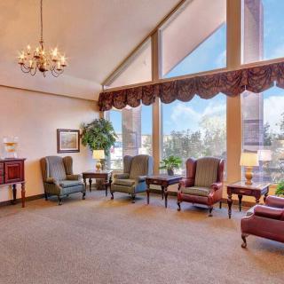 A spacious lounge area with elegant furniture and large windows.