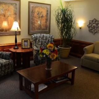 A cozy living room setting featuring comfortable seating, warm lighting, and decorative elements.