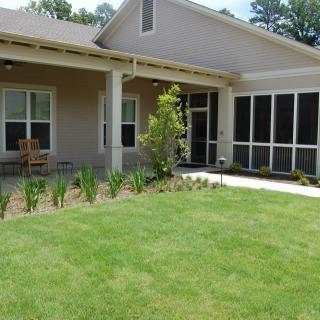 A modern house with a well-maintained lawn and garden.