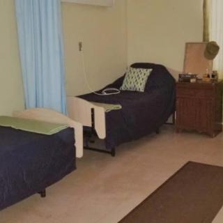 A cozy bedroom with comfortable furniture and simple decor.