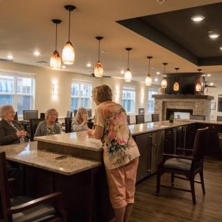 A group of people enjoying a social gathering at a restaurant's bar area.