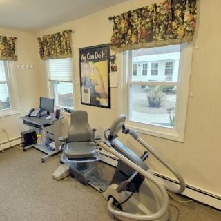 A small indoor gym with exercise equipment and natural light.