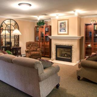 A cozy living room featuring comfortable seating and a warm fireplace.