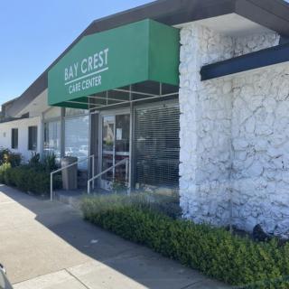 The exterior of a building with a green awning reading 'Bay Crest Catering'.