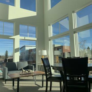 A modern living room with large windows letting in abundant natural light.