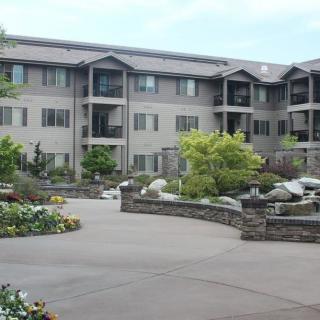 A well-maintained apartment building with beautiful landscaping and garden features.