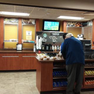 A man browsing the offerings at a coffee shop.