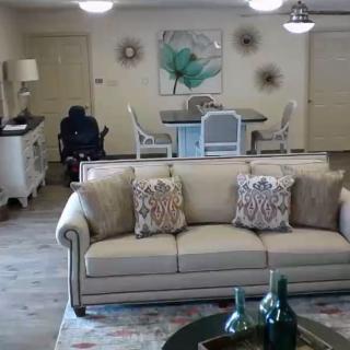 A cozy living room with a beige sofa, elegant furniture, and stylish decor.