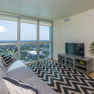 A modern living room with large windows offering a scenic city view.