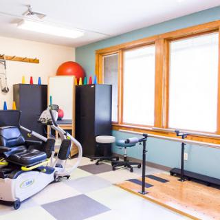 A well-equipped therapy room featuring various rehabilitation tools and equipment for physical therapy.