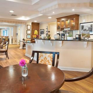 A modern kitchen and dining area with elegant decor and wood flooring.