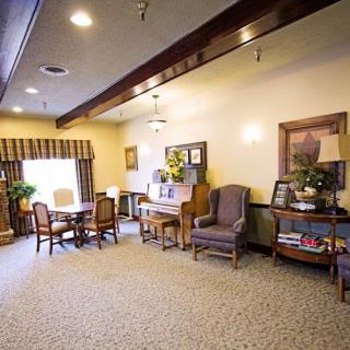 A cozy living room space featuring comfortable seating and a small dining area.